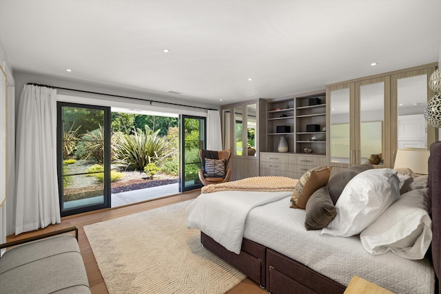 bedroom with light wood-type flooring and access to outside