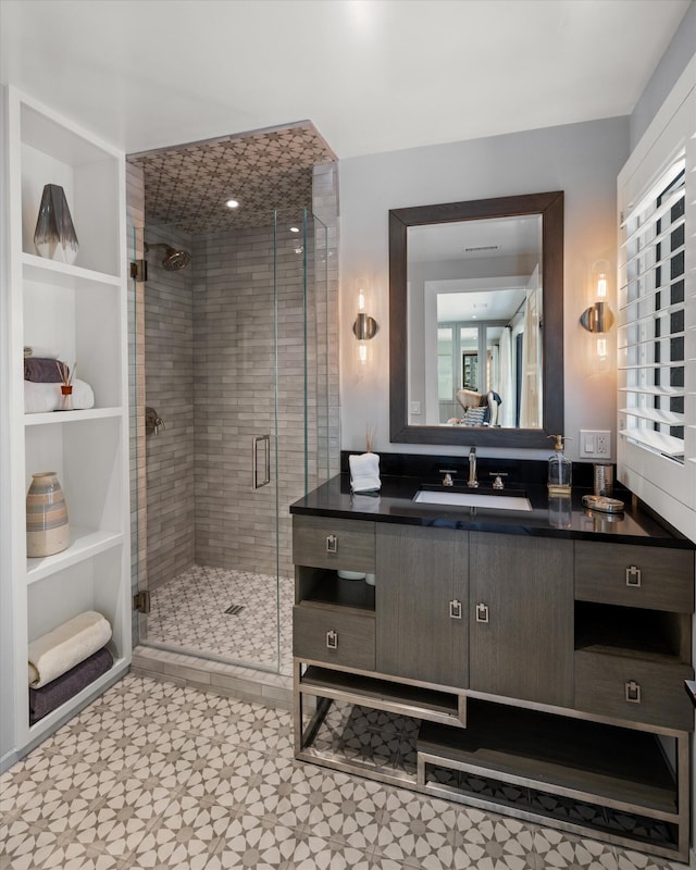 bathroom featuring tile patterned flooring, vanity, and an enclosed shower