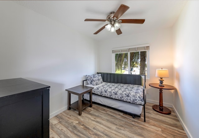 bedroom featuring hardwood / wood-style floors and ceiling fan