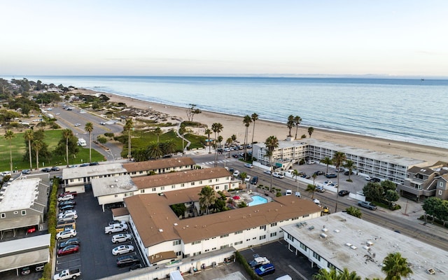 aerial view with a water view and a beach view