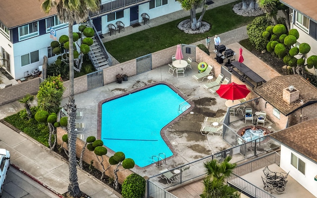 view of swimming pool featuring a yard and a patio area