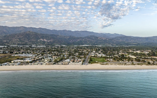 property view of water featuring a mountain view and a beach view