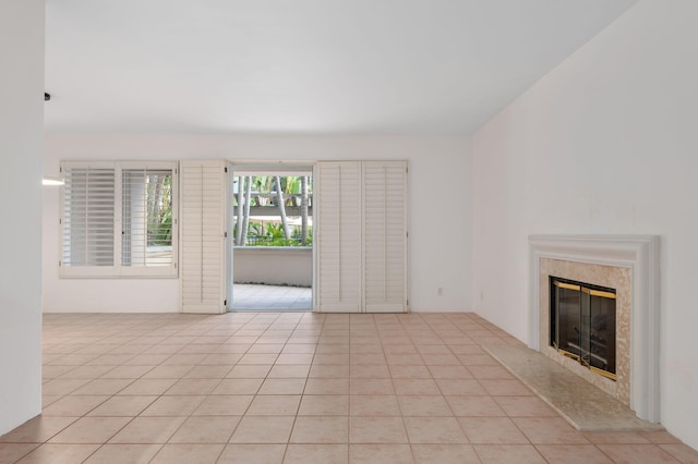 unfurnished living room featuring a fireplace and light tile patterned floors