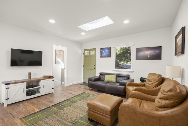 living room with wood-type flooring and a skylight