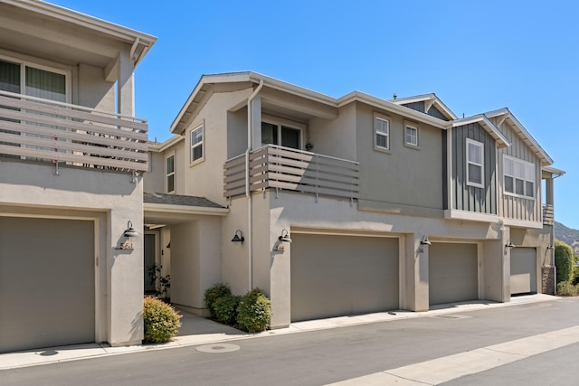 multi unit property featuring a balcony and a garage