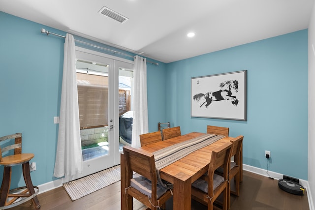 dining space with french doors and dark hardwood / wood-style flooring