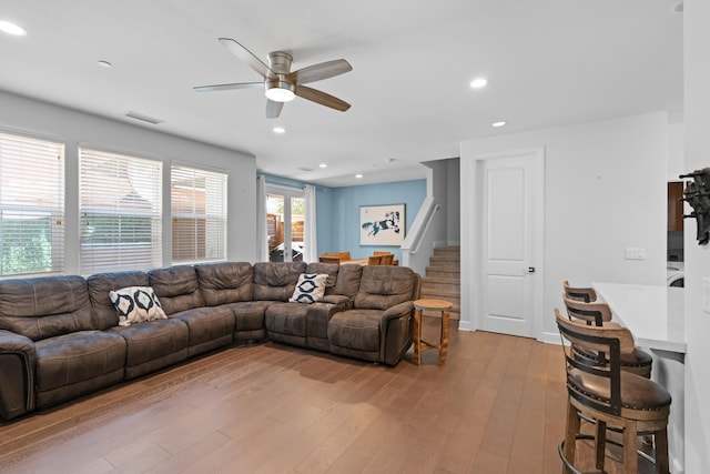 living room with light wood-type flooring and ceiling fan