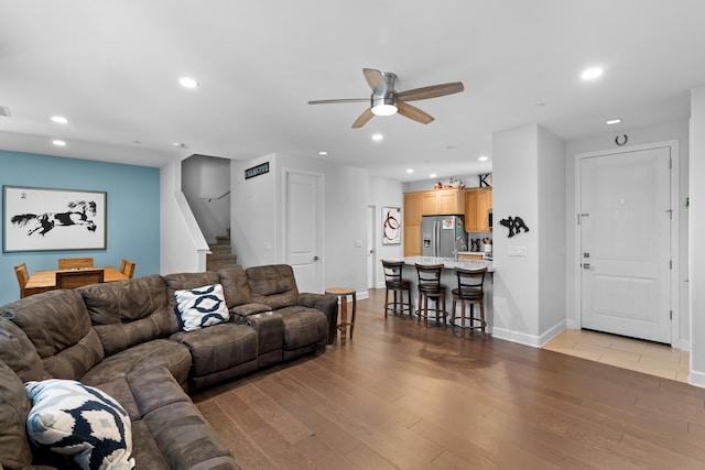 living room featuring ceiling fan and hardwood / wood-style flooring