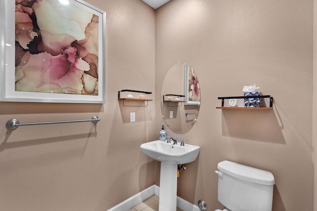 bathroom featuring tile patterned flooring and toilet