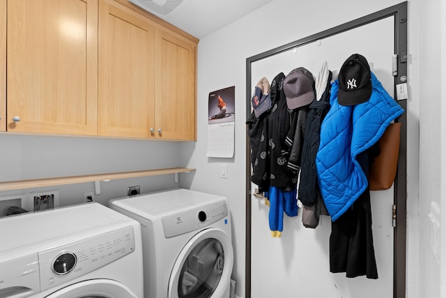 laundry area featuring washer and dryer and cabinets