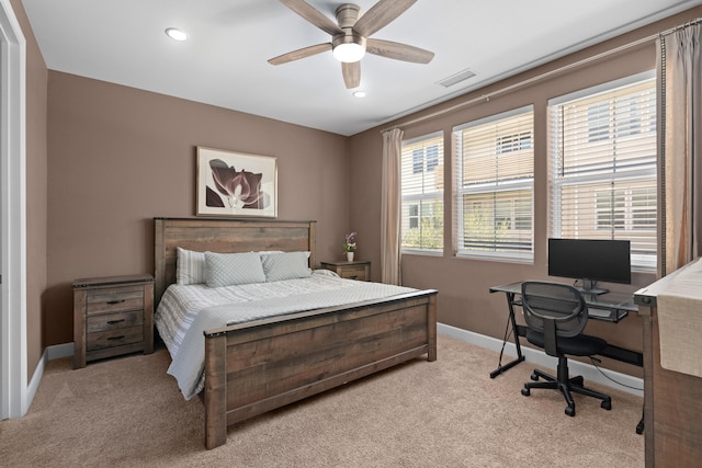 carpeted bedroom featuring multiple windows and ceiling fan