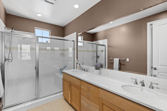 bathroom with tile patterned flooring, an enclosed shower, and vanity