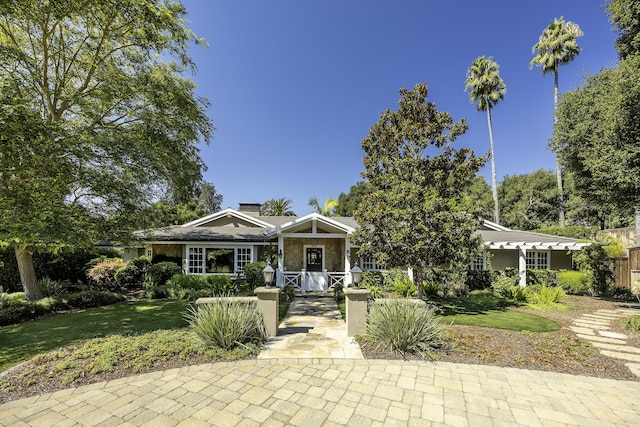 view of front of home featuring covered porch and a front yard