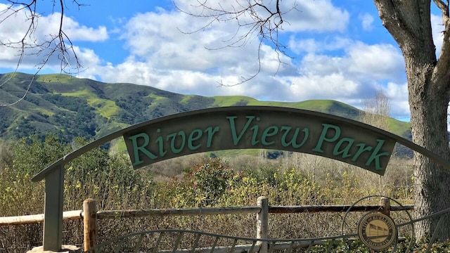 community sign with a mountain view