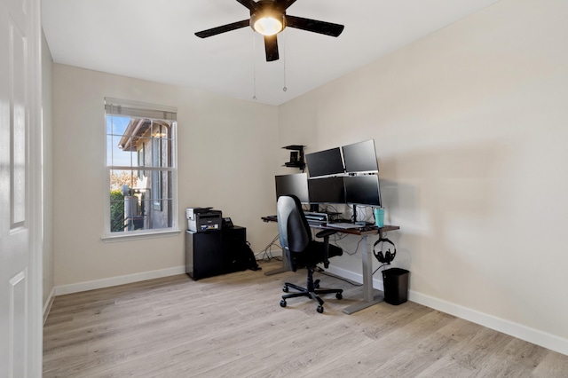 office area with ceiling fan, baseboards, and light wood-style flooring