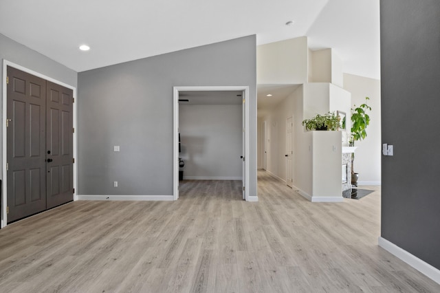 entryway featuring recessed lighting, light wood-style floors, baseboards, and high vaulted ceiling