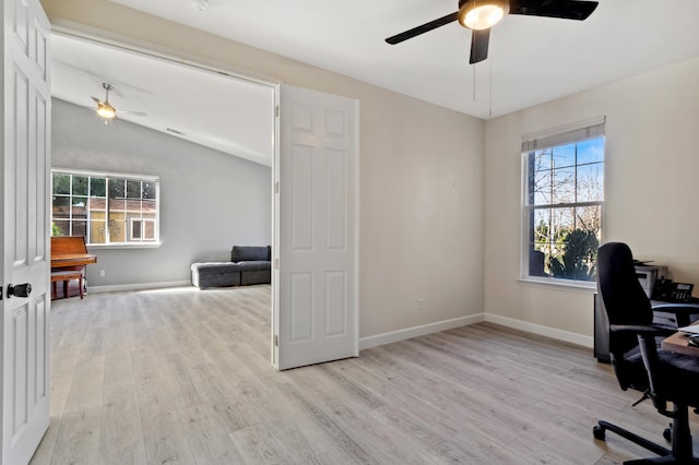 office area featuring vaulted ceiling, light wood-style flooring, baseboards, and ceiling fan