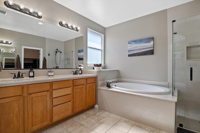 bathroom with double vanity, a stall shower, a sink, tile patterned flooring, and a bath