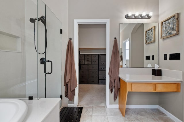 full bath with a walk in closet, vanity, a tub, and a stall shower