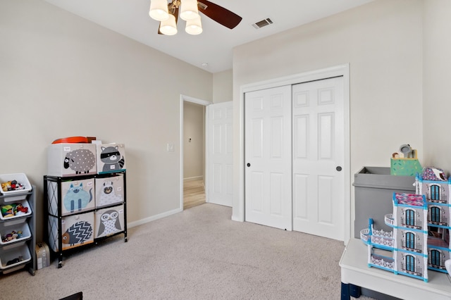 rec room with baseboards, visible vents, a ceiling fan, and carpet