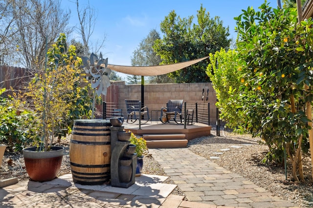 view of patio / terrace with a wooden deck and fence