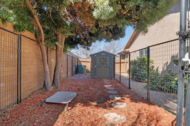 view of yard featuring a storage unit, an outdoor structure, and a fenced backyard