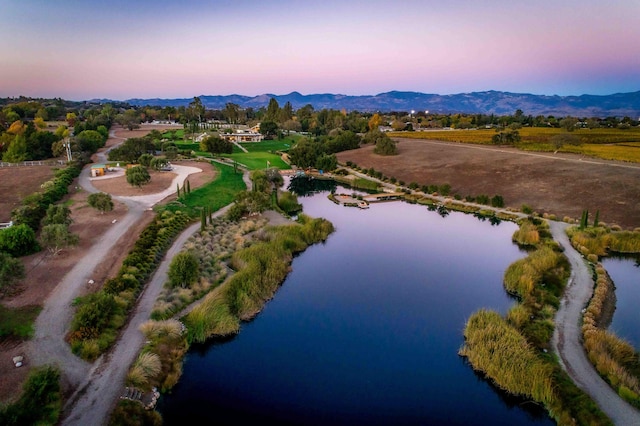 aerial view at dusk with a water and mountain view