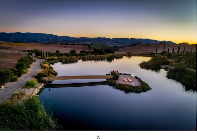 aerial view at dusk with a water and mountain view