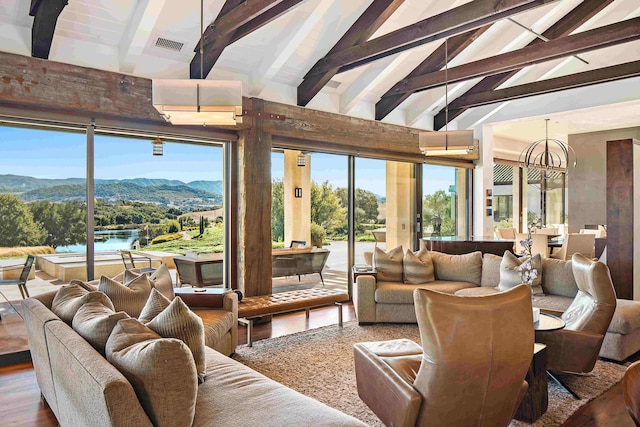 living room featuring high vaulted ceiling, beamed ceiling, wood-type flooring, an inviting chandelier, and a water and mountain view