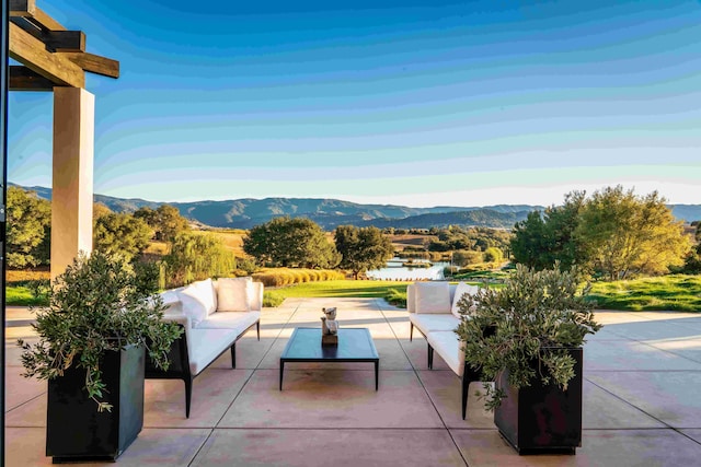 view of patio / terrace featuring a mountain view and an outdoor hangout area