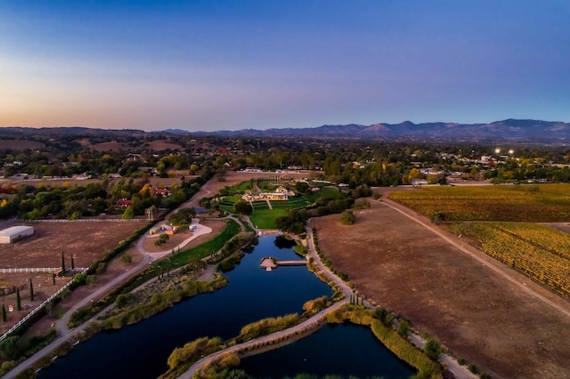 aerial view at dusk with a water and mountain view