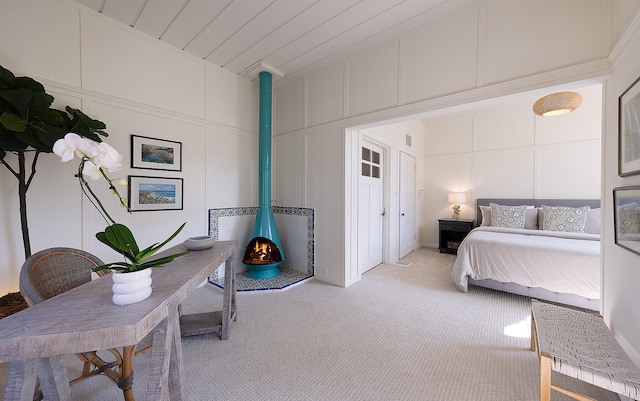 carpeted bedroom with a wood stove