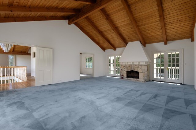 unfurnished living room featuring french doors, wood ceiling, high vaulted ceiling, and carpet