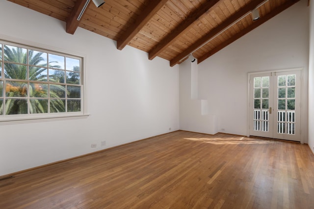 empty room with french doors, high vaulted ceiling, wood-type flooring, and wooden ceiling