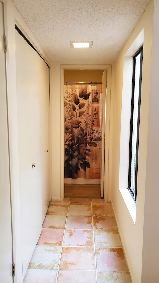 hallway featuring a textured ceiling