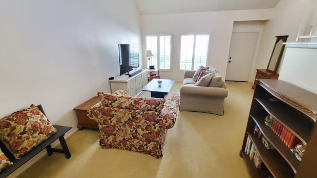 living area featuring light colored carpet and vaulted ceiling