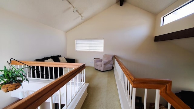 bedroom with lofted ceiling with beams and rail lighting