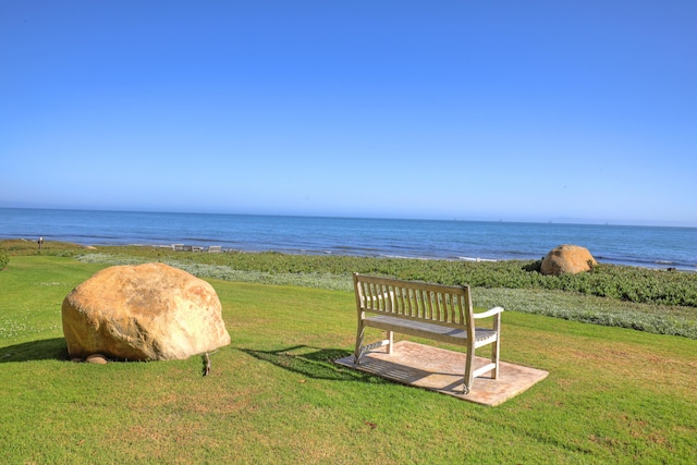 view of property's community featuring a yard and a water view