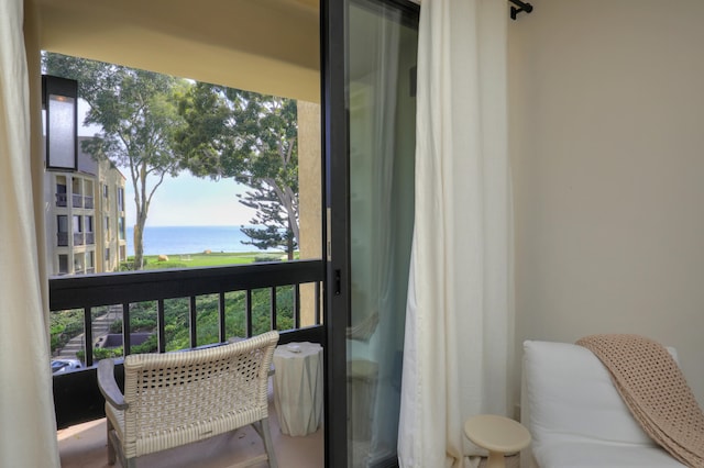 balcony featuring a water view