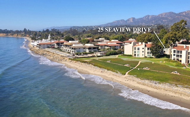 birds eye view of property with a view of the beach and a water and mountain view