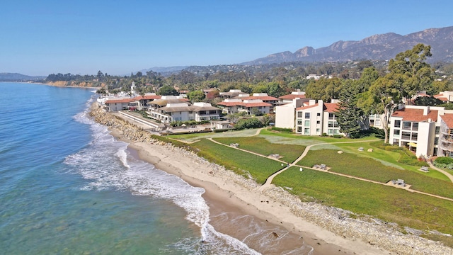 aerial view featuring a view of the beach and a water and mountain view