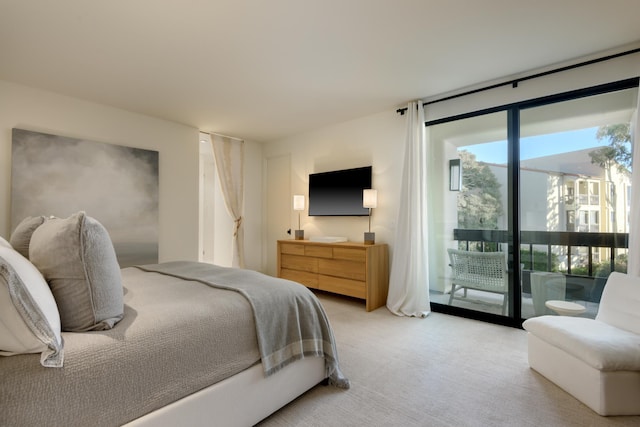 bedroom featuring light carpet and access to outside