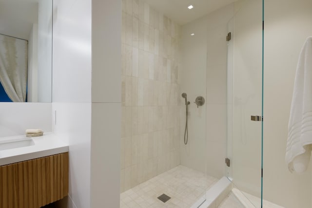 bathroom featuring vanity and an enclosed shower