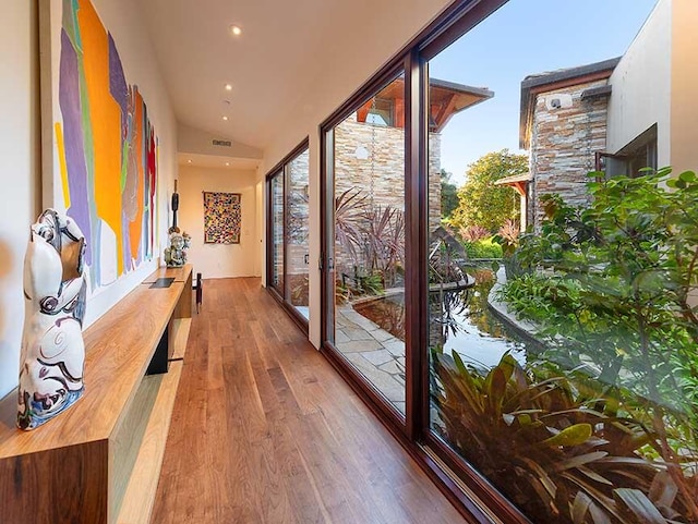 entryway featuring hardwood / wood-style flooring and vaulted ceiling