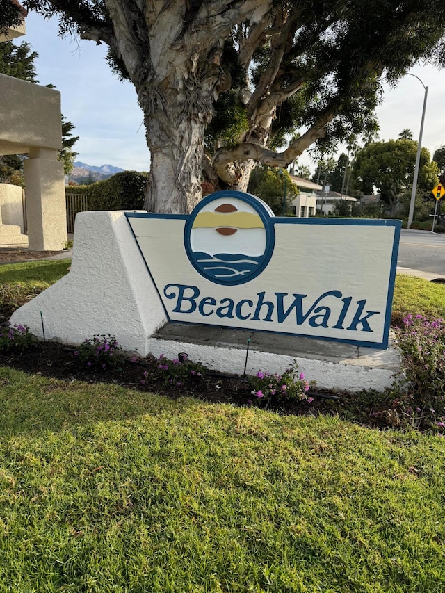 community sign featuring a lawn