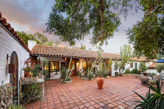 view of patio terrace at dusk