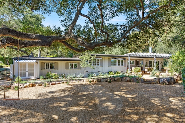 rear view of property with covered porch