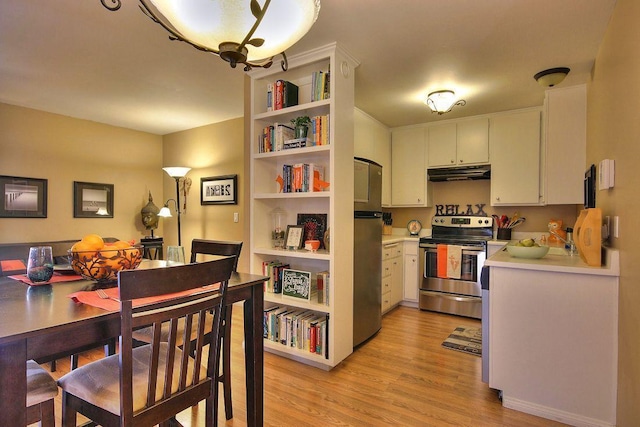 kitchen with light hardwood / wood-style flooring, stainless steel appliances, and white cabinets