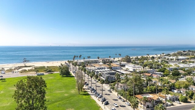 aerial view with a water view and a beach view