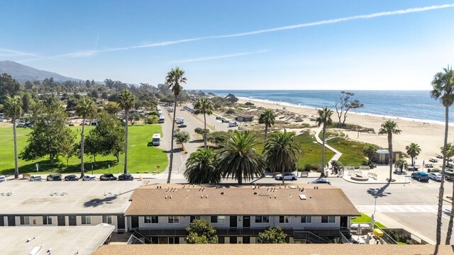 birds eye view of property with a water view and a view of the beach